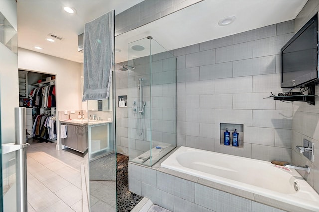 5507 Darling St, Houston, TX 77007 - full bath with a tile shower, a bath, vanity, a walk in closet, and tile patterned floors