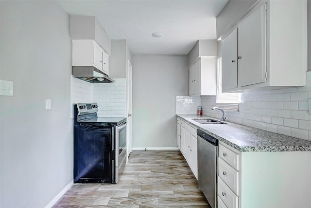 4969 E Rdg Creek Dr, Houston, TX 77053 - kitchen with appliances with stainless steel finishes, a sink, under cabinet range hood, tasteful backsplash, and white cabinets
