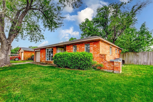 ranch-style house featuring an attached garage, brick siding, driveway, and central AC unit