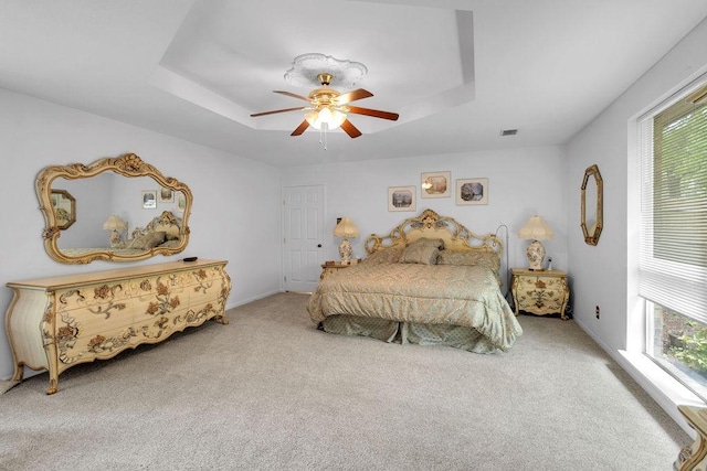 24930 Plantation Estates Ave, Porter, TX 77365 - carpeted bedroom featuring a tray ceiling and a ceiling fan