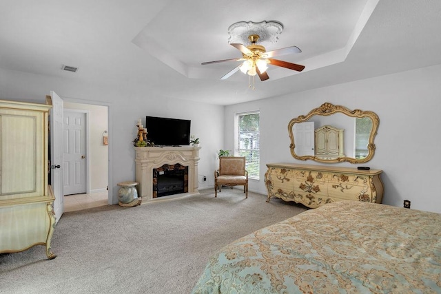 24930 Plantation Estates Ave, Porter, TX 77365 - bedroom with a tray ceiling, carpet floors, a fireplace, and ceiling fan