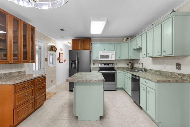 24930 Plantation Estates Ave, Porter, TX 77365 - kitchen featuring appliances with stainless steel finishes, a sink, a center island, glass insert cabinets, and tasteful backsplash