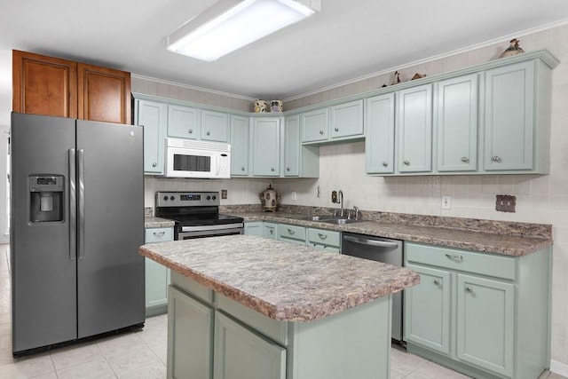 24930 Plantation Estates Ave, Porter, TX 77365 - kitchen with appliances with stainless steel finishes, light tile patterned floors, a sink, a kitchen island, and crown molding