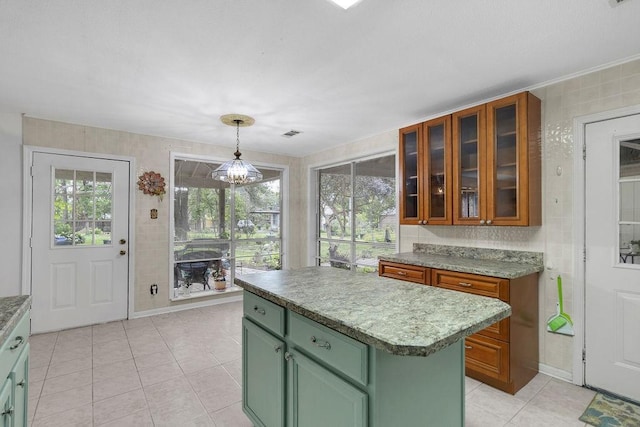 24930 Plantation Estates Ave, Porter, TX 77365 - kitchen with green cabinets, light tile patterned floors, a kitchen island, glass insert cabinets, and a chandelier