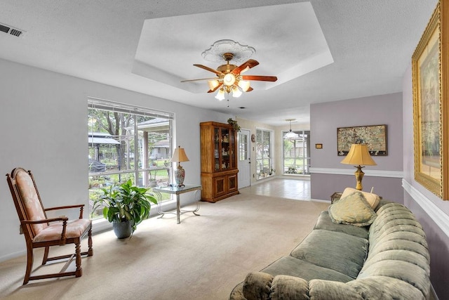 24930 Plantation Estates Ave, Porter, TX 77365 - living area with a ceiling fan, light carpet, a tray ceiling, and healthy amount of natural light
