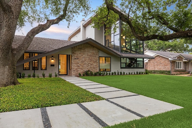 5686 Bayou Glen Rd, Houston, TX 77056 - view of front facade featuring brick siding and a yard