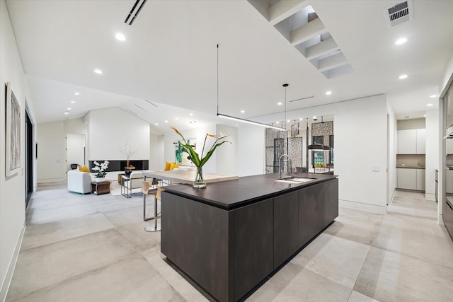 5686 Bayou Glen Rd, Houston, TX 77056 - kitchen with a sink, modern cabinets, dark countertops, a large island with sink, and recessed lighting