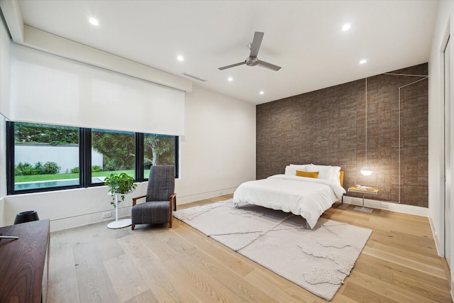5686 Bayou Glen Rd, Houston, TX 77056 - bedroom featuring recessed lighting, light wood-type flooring, an accent wall, a ceiling fan, and baseboards