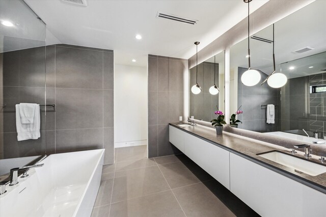 5686 Bayou Glen Rd, Houston, TX 77056 - full bath featuring tile walls, a tub, tile patterned floors, double vanity, and recessed lighting