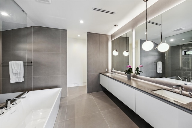 5686 Bayou Glen Rd, Houston, TX 77056 - bathroom with tile walls, a freestanding tub, double vanity, tile patterned floors, and recessed lighting