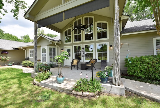 back of house featuring ceiling fan and a lawn