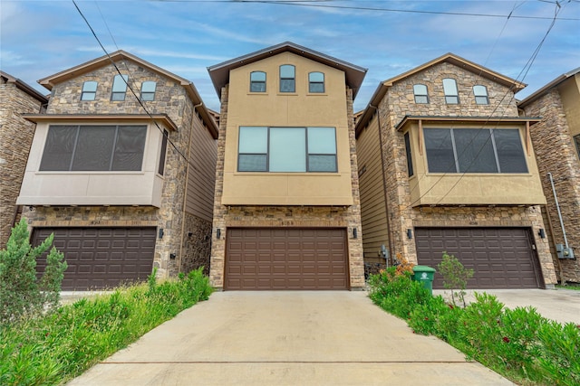 406 Fenn St Unit A, Houston, TX 77018 - view of front of property with an attached garage, stone siding, and concrete driveway