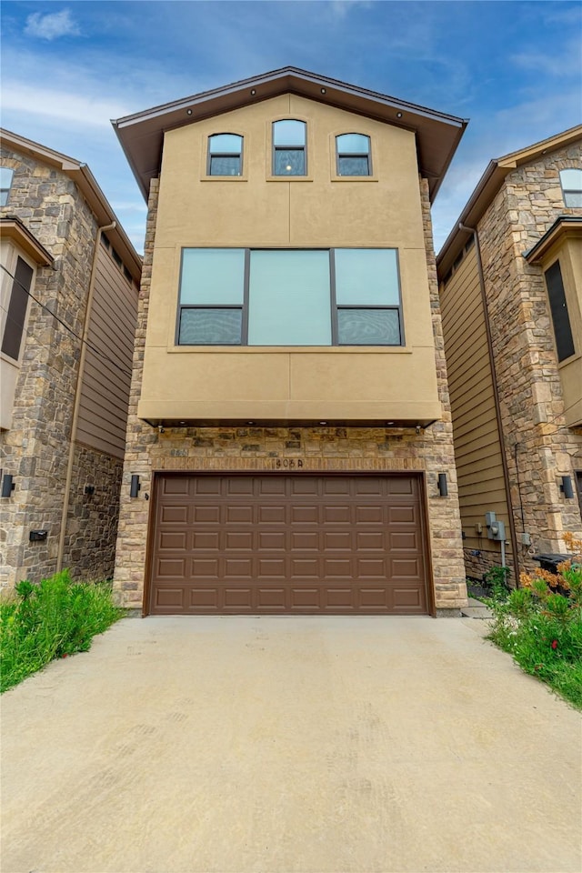 406 Fenn St Unit A, Houston, TX 77018 - view of front of property with an attached garage, driveway, stucco siding, and stone siding