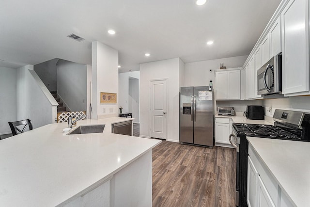 4319 Liberty Ranch Way, Baytown, TX 77521 - kitchen with stainless steel appliances, a sink, light countertops, dark wood-style floors, and recessed lighting