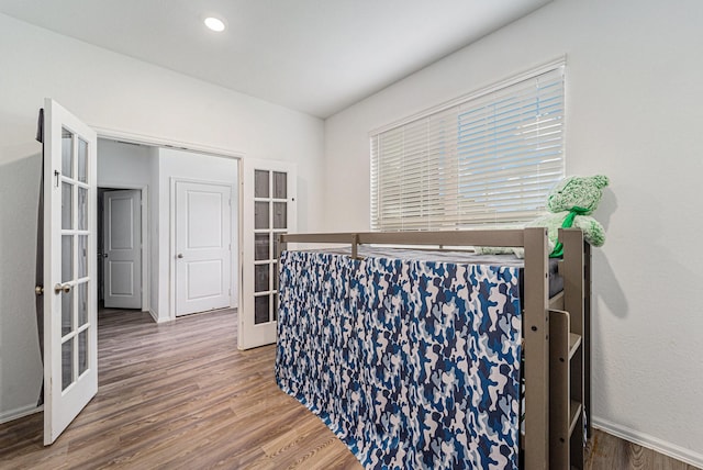 4319 Liberty Ranch Way, Baytown, TX 77521 - hallway featuring french doors, wood finished floors, and baseboards