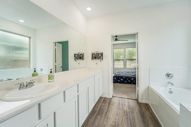 4319 Liberty Ranch Way, Baytown, TX 77521 - bathroom with wood finished floors, a garden tub, vanity, a ceiling fan, and ensuite bath