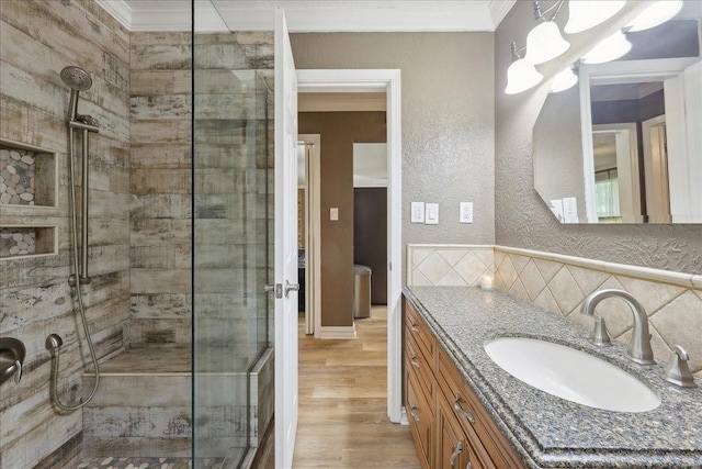 985 Sunnyside Dr, Bridge City, TX 77611 - bathroom featuring a shower stall, ornamental molding, vanity, wood finished floors, and a textured wall