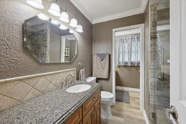 985 Sunnyside Dr, Bridge City, TX 77611 - bathroom with a textured wall, a stall shower, wood finished floors, toilet, and crown molding