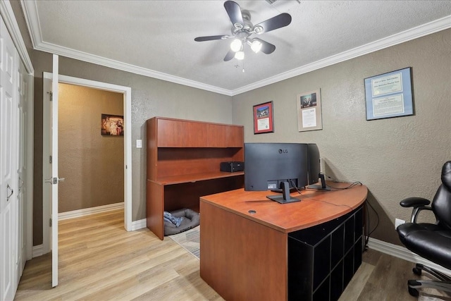 985 Sunnyside Dr, Bridge City, TX 77611 - home office featuring a textured wall, light wood finished floors, ceiling fan, baseboards, and crown molding