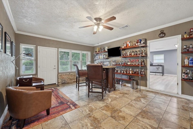 985 Sunnyside Dr, Bridge City, TX 77611 - indoor dry bar with a ceiling fan, healthy amount of natural light, a textured ceiling, ornamental molding, and baseboards