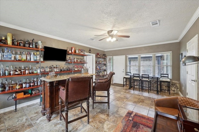 985 Sunnyside Dr, Bridge City, TX 77611 - indoor dry bar with a ceiling fan, ornamental molding, a textured ceiling, and baseboards