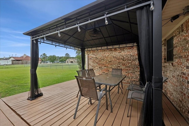 985 Sunnyside Dr, Bridge City, TX 77611 - wooden terrace featuring a gazebo and outdoor dining space