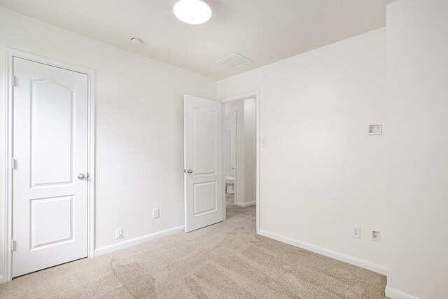 unfurnished bedroom featuring carpet and baseboards