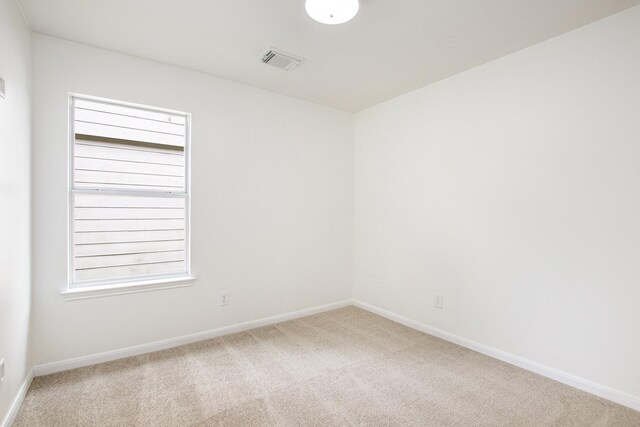 carpeted spare room with baseboards and healthy amount of natural light
