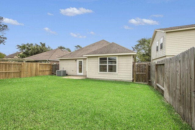 back of property with roof with shingles and central AC