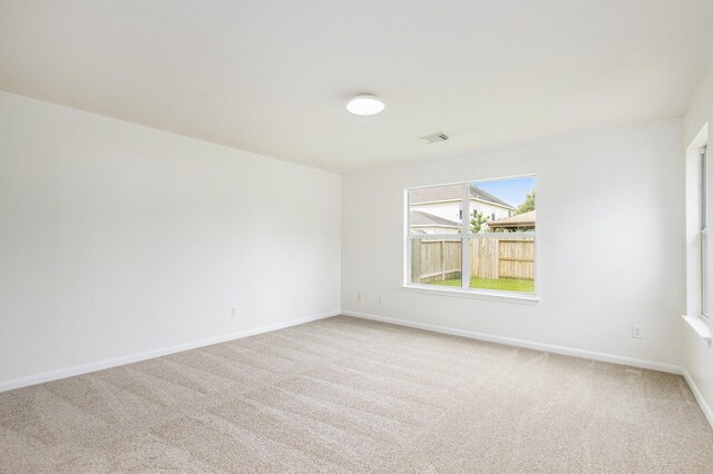 carpeted empty room with baseboards