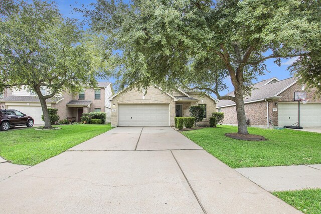 view of front of home featuring a front lawn, concrete driveway, and a garage