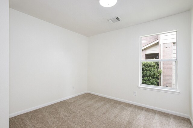 carpeted empty room with baseboards