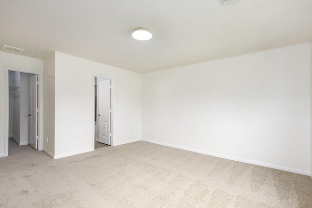 empty room featuring carpet flooring and baseboards
