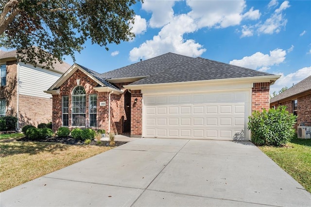 ranch-style home featuring brick siding, driveway, a garage, and roof with shingles