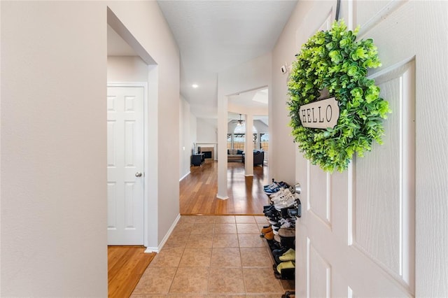 entrance foyer with light tile patterned floors, baseboards, ceiling fan, and recessed lighting