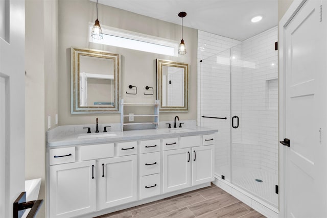 2609 Paul Quinn St, Houston, TX 77091 - bathroom with double vanity, a stall shower, and wood finished floors