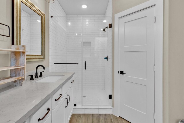 2609 Paul Quinn St, Houston, TX 77091 - bathroom featuring vanity, a shower stall, wood finished floors, and recessed lighting