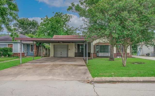 single story home with an attached garage, a front yard, and concrete driveway