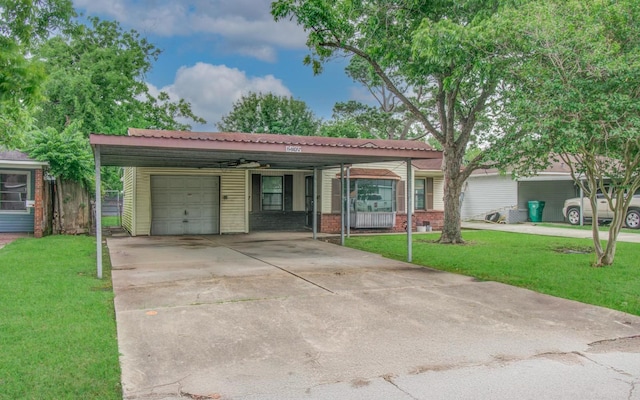 single story home with a front yard, a garage, driveway, and brick siding