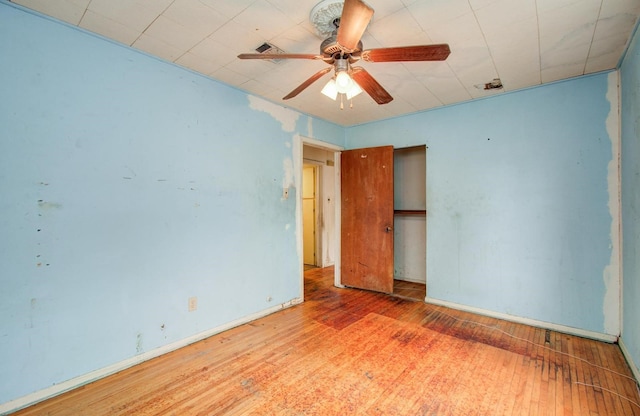 unfurnished bedroom featuring wood-type flooring, baseboards, and ceiling fan