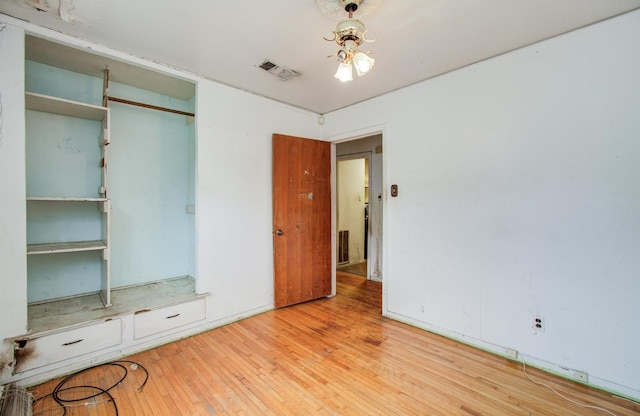 unfurnished bedroom featuring wood finished floors and a closet
