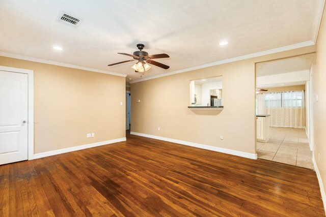 empty room with a ceiling fan, wood-type flooring, baseboards, crown molding, and recessed lighting