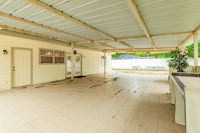 view of patio with french doors and fence