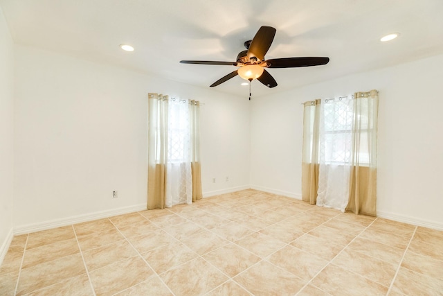 spare room with a ceiling fan and recessed lighting