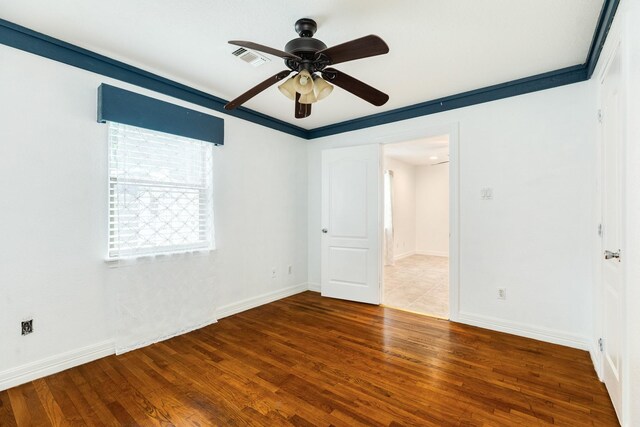 unfurnished bedroom with wood finished floors, baseboards, and ceiling fan