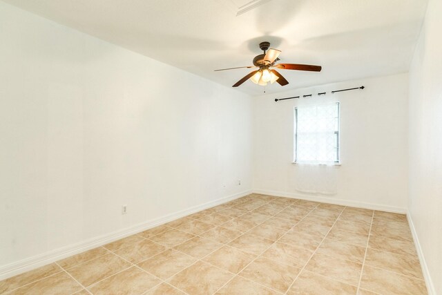 unfurnished room featuring ceiling fan and baseboards