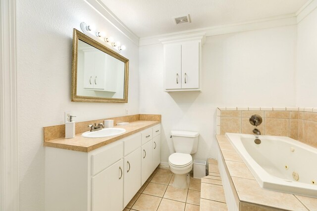 bathroom featuring toilet, a whirlpool tub, tile patterned floors, vanity, and baseboards