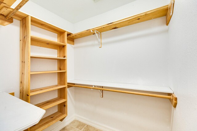 spacious closet featuring light tile patterned flooring