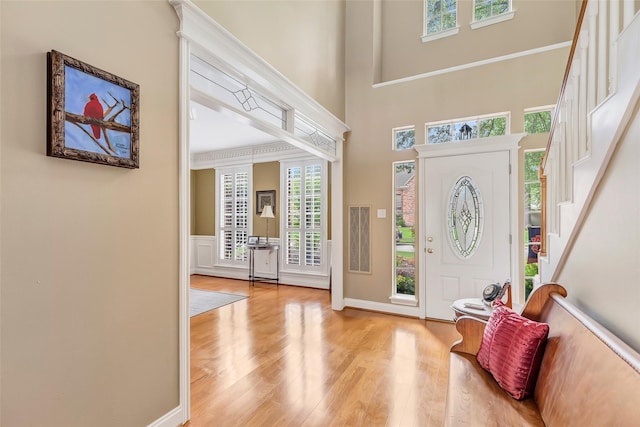 5810 Redwood River Dr, Kingwood, TX 77345 - foyer entrance with wood finished floors, stairs, a high ceiling, baseboards, and wainscoting