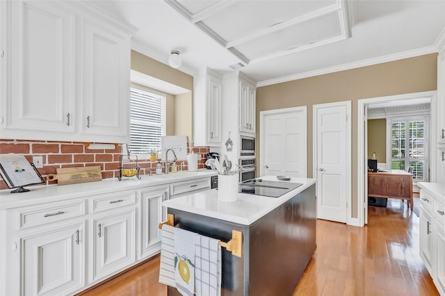 5810 Redwood River Dr, Kingwood, TX 77345 - kitchen featuring a sink, stainless steel appliances, light countertops, backsplash, and white cabinetry